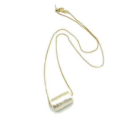 Necklace with a cylindrical pendant on a white background
