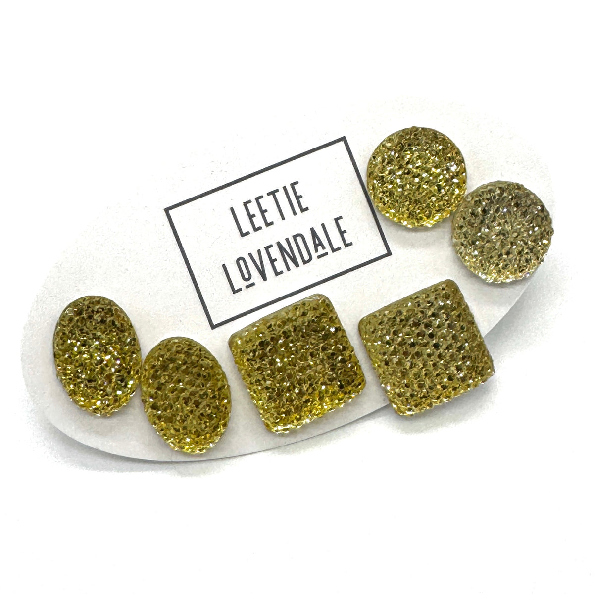 Yellow textured stud earrings on a white card with Leetie Lovendale branding on a white background.