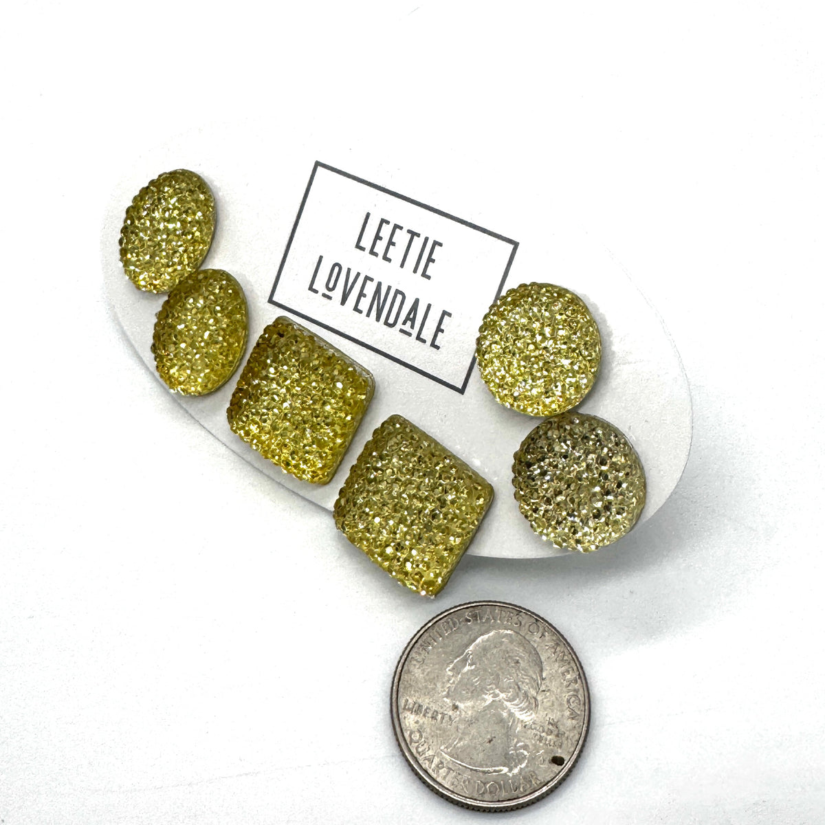 Yellow textured stud earrings on a white card with Leetie Lovendale branding on a white background.