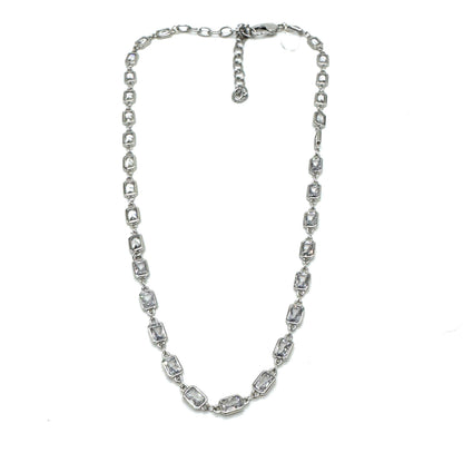 Silver necklace with clear stones on a white background